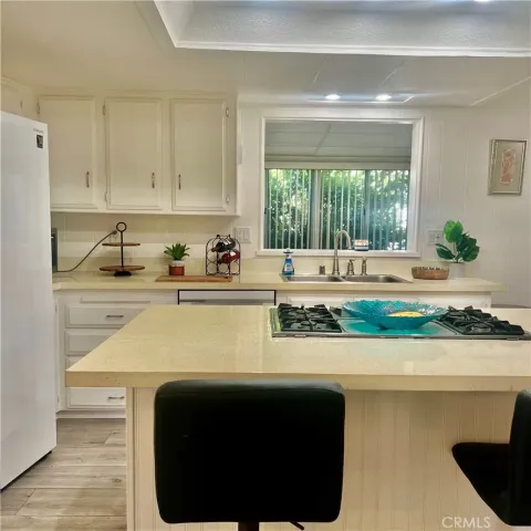 a kitchen with a sink and a stove top oven