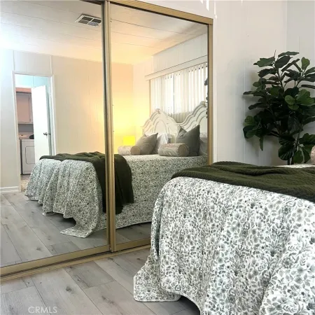 a bedroom with a bed and a potted plant