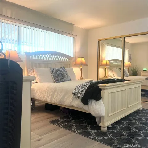 a bedroom with a bed and a large window