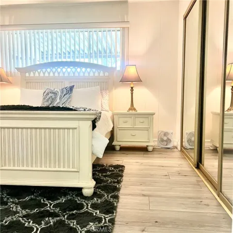 a view of a room with wooden floor table and chairs