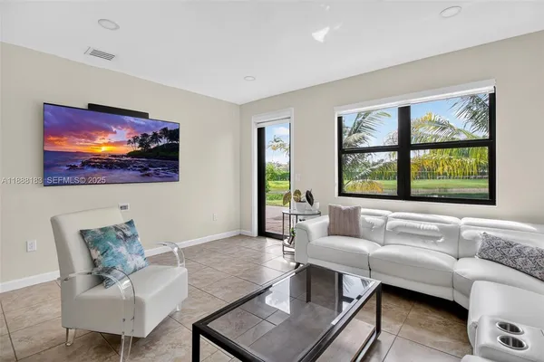 a living room with furniture and a large window