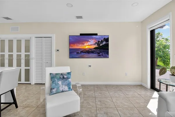 a living room with furniture and kitchen view