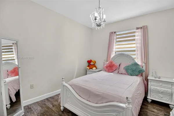 a bedroom with a bed a bookshelf and a window