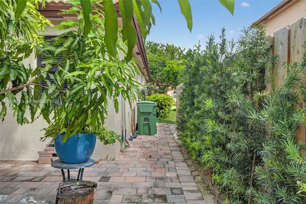 a view of a backyard with sitting area and garden