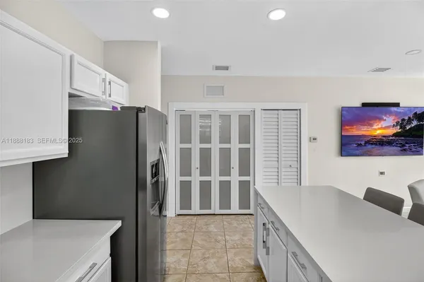a kitchen with stainless steel appliances a refrigerator sink and microwave