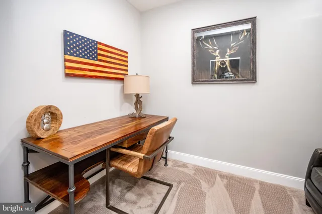 a room with furniture pool table wooden floor and windows