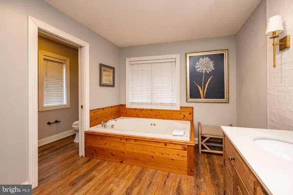 a bedroom with a large bed and a flat screen tv