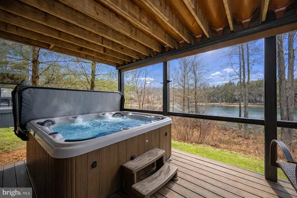 a dining room with furniture wooden floor a rug and a chandelier