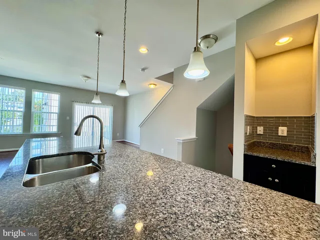 a large kitchen with a large window and stainless steel appliances