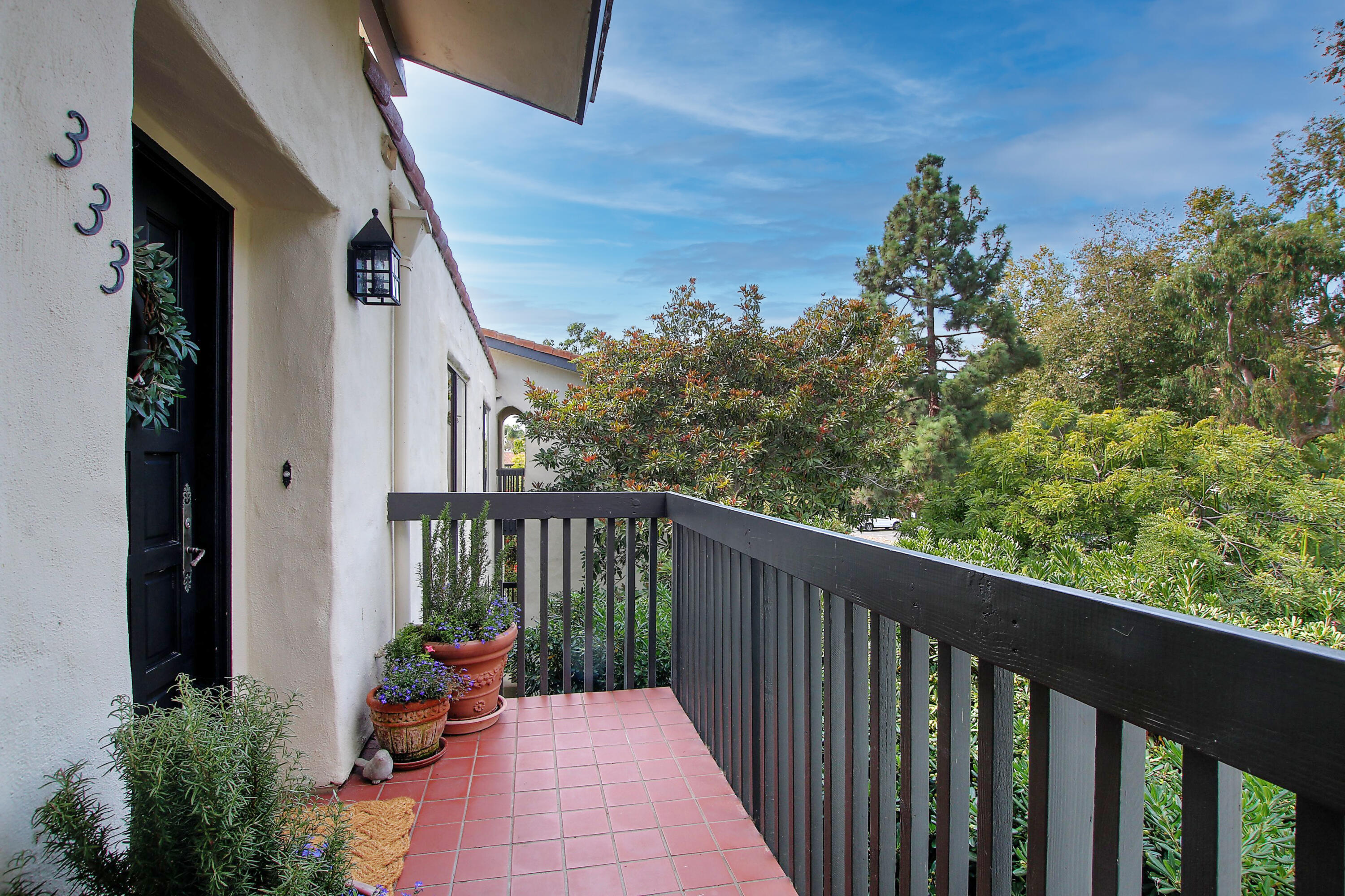 3375 Foothill Road, Unit 333 Carpinteria, CA 93013 - Photo 18 of 23 a balcony with wooden floor and outdoor seating