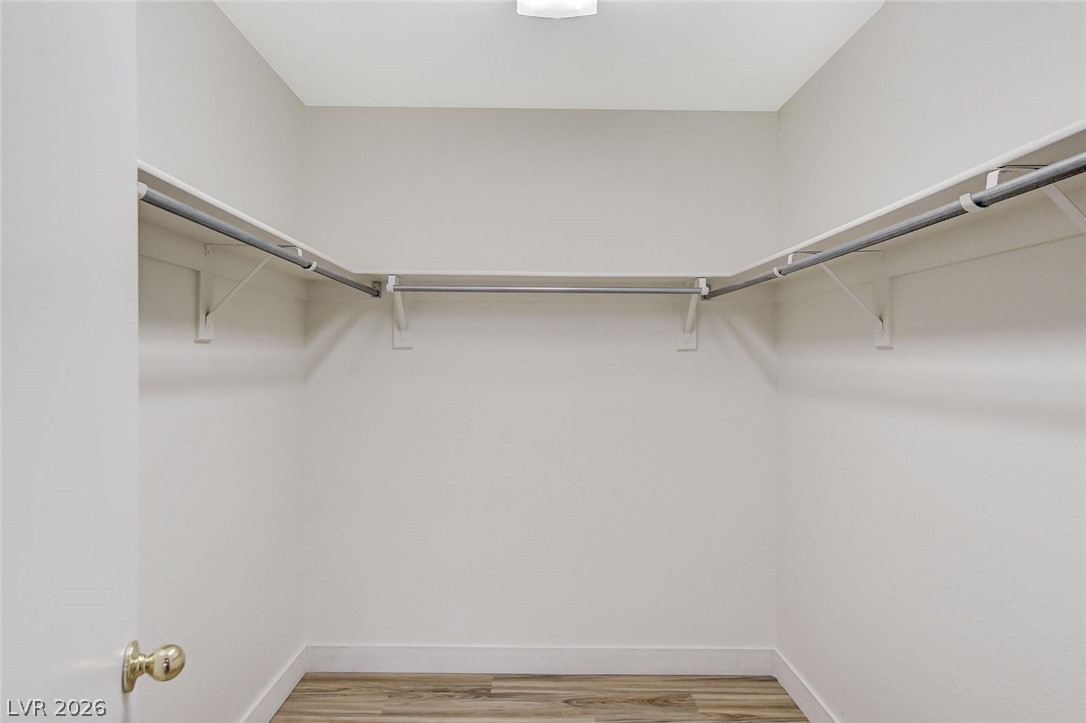 2052 Quarry Ridge Street, Unit 201 Las Vegas, NV 89117 - Photo 18 of 25 An organized walk-in closet with ample hanging space and durable flooring awaits.