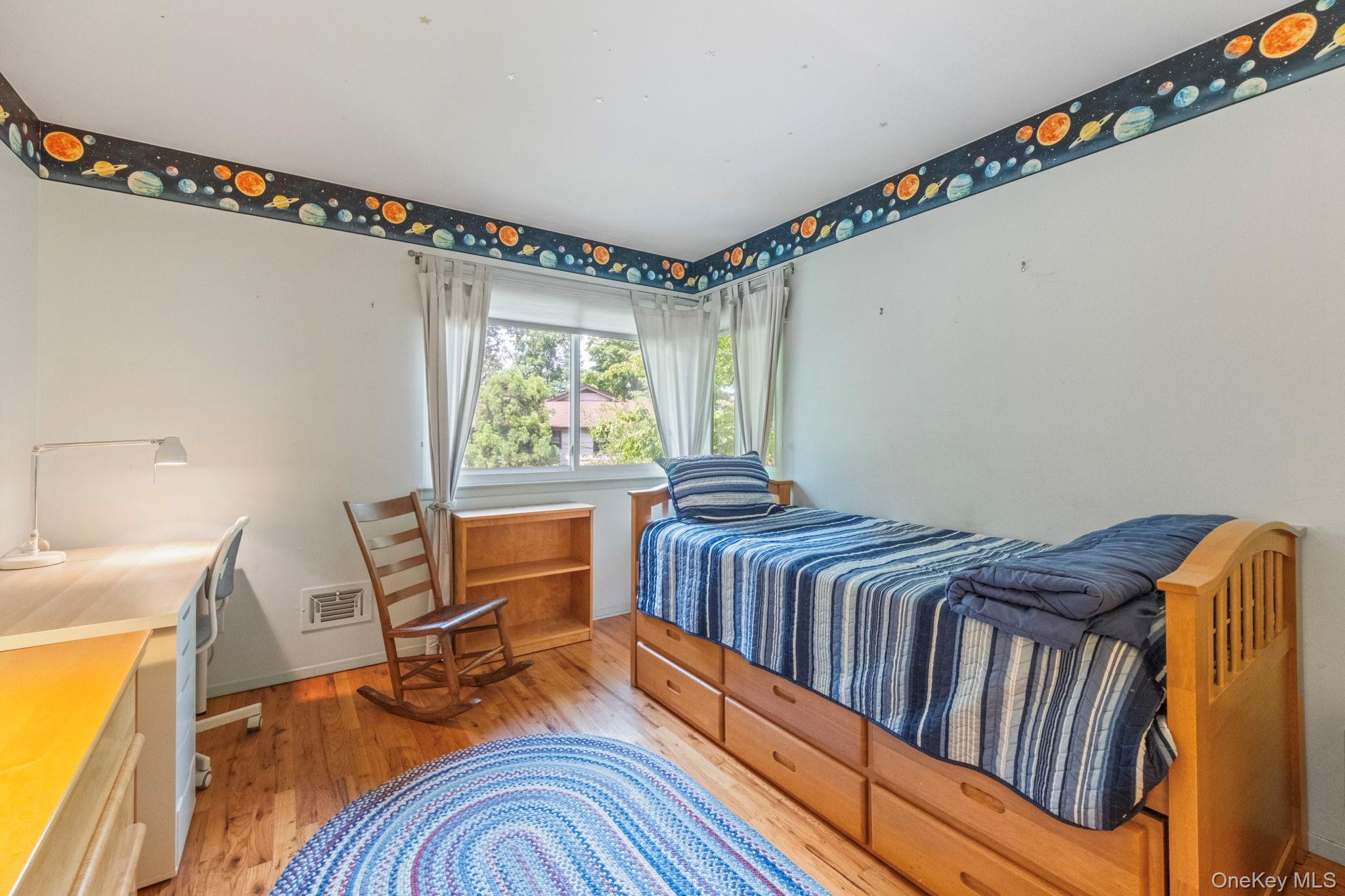 73 Bramblebrook Road Ardsley, NY 10502 - Photo 15 of 35 Hardwood flooring complements a light blue interior featuring a corner window