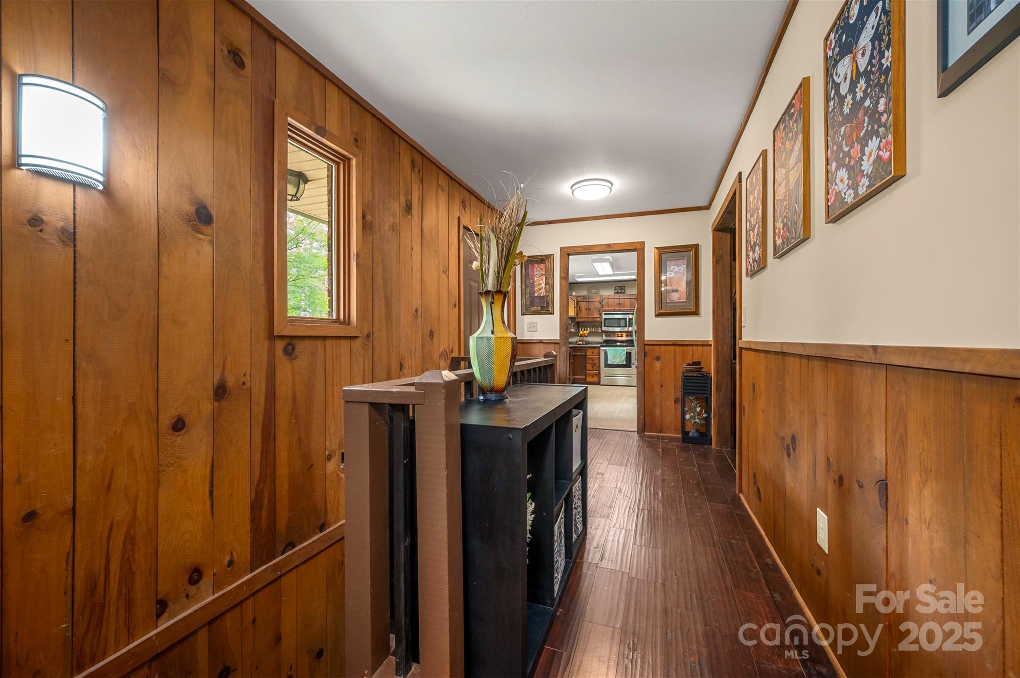 307 Owl Hollow Road Mill Spring, NC 28756 - Photo 14 of 31 a view of a hallway with wooden floor and staircase