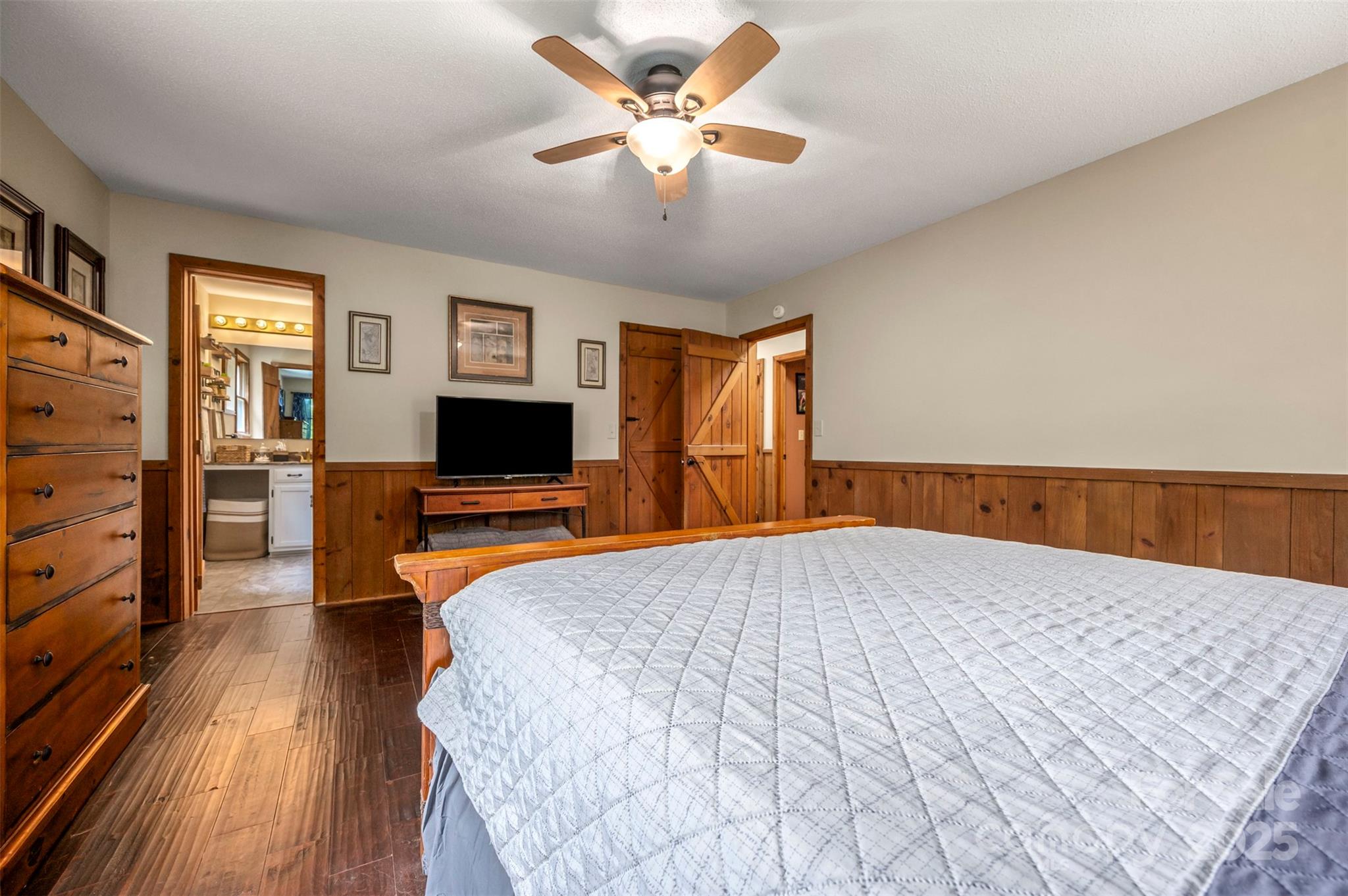 307 Owl Hollow Road Mill Spring, NC 28756 - Photo 16 of 31 a bedroom with a bed and a flat screen tv