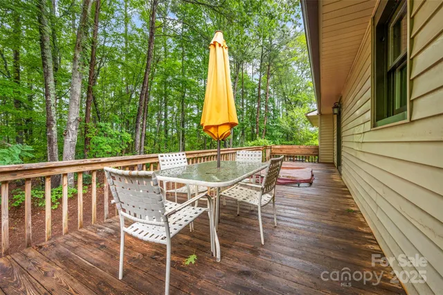 a view of a chairs and table on the wooden deck