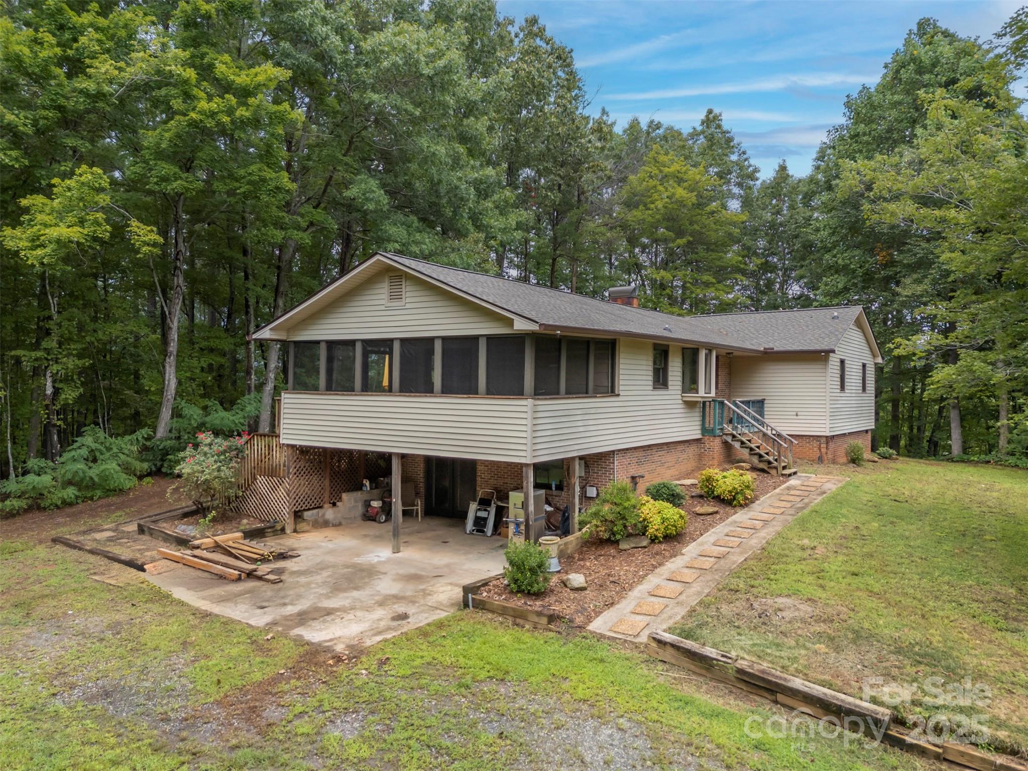 307 Owl Hollow Road Mill Spring, NC 28756 - Photo 2 of 31 a view of a house with backyard and sitting area