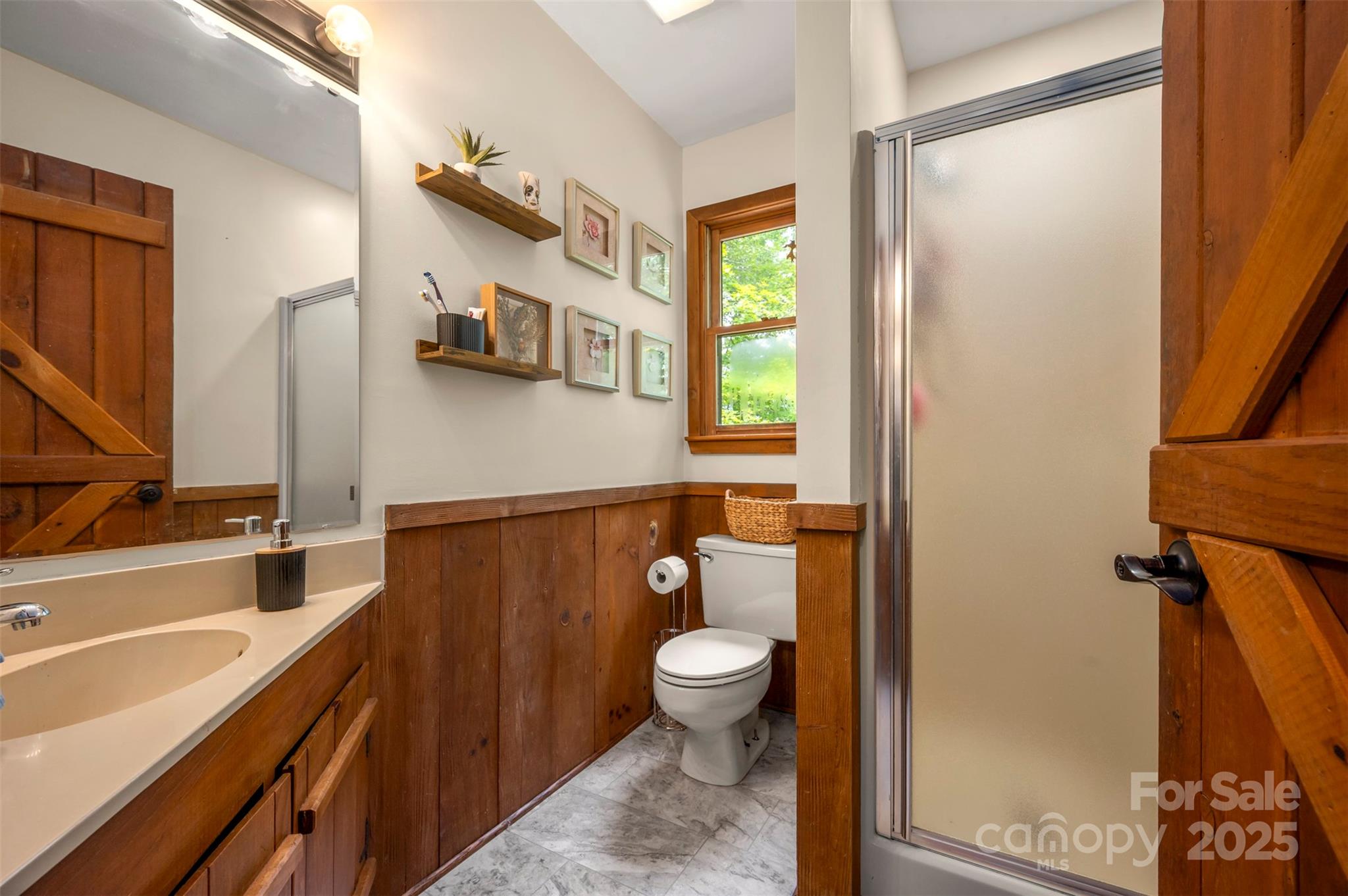 307 Owl Hollow Road Mill Spring, NC 28756 - Photo 21 of 31 a bathroom with a granite countertop sink toilet and shower