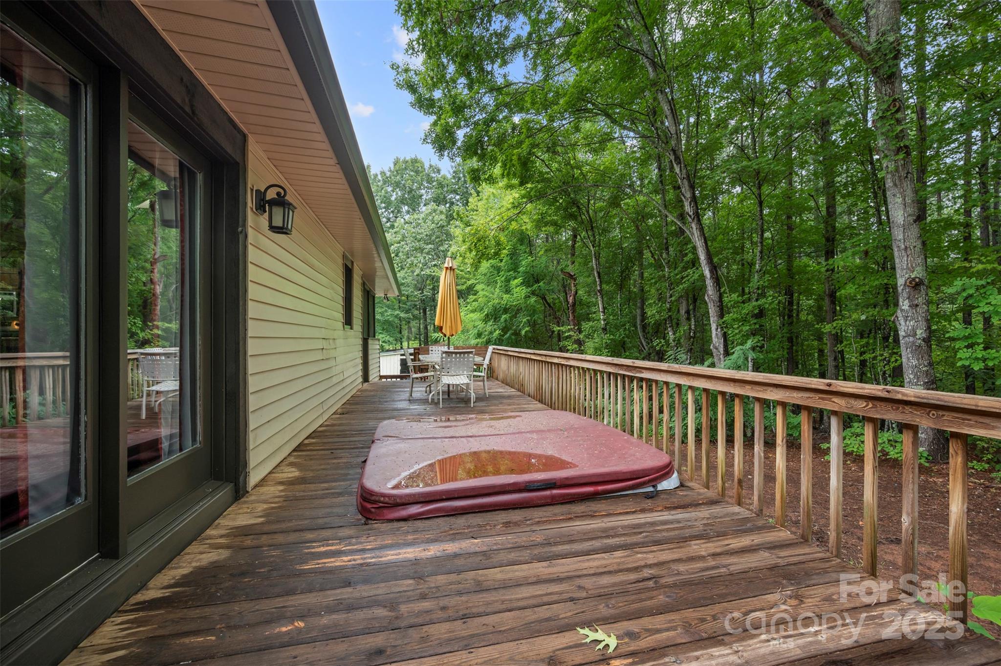 307 Owl Hollow Road Mill Spring, NC 28756 - Photo 23 of 31 a view of balcony with wooden floor and outdoor seating