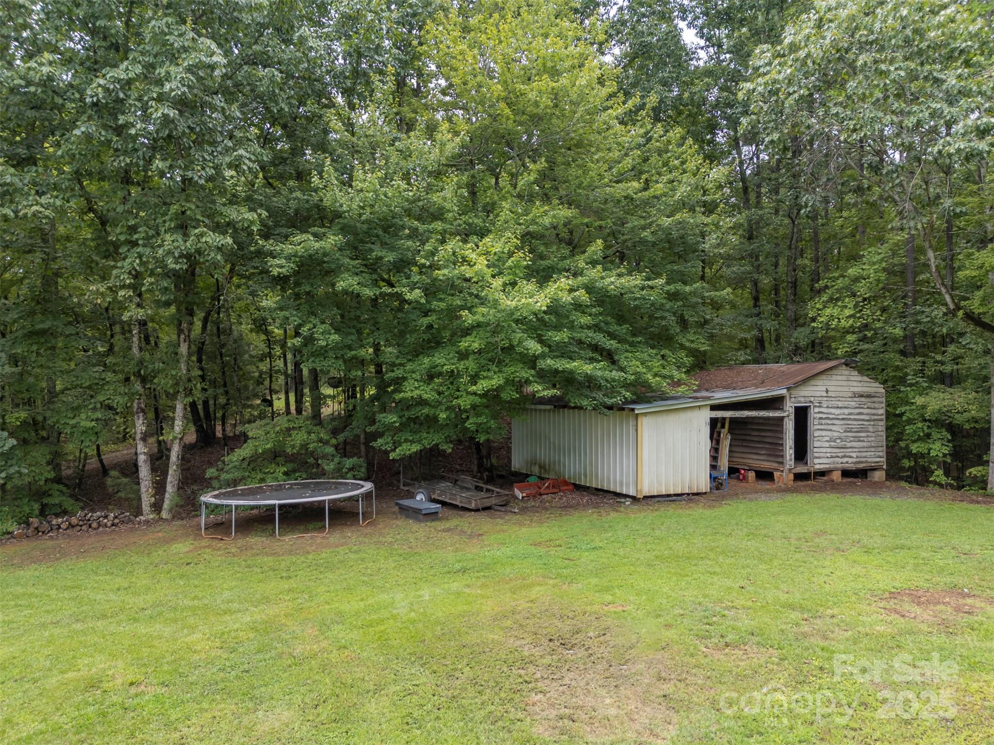 307 Owl Hollow Road Mill Spring, NC 28756 - Photo 28 of 31 a view of a chair and table on the wooden deck