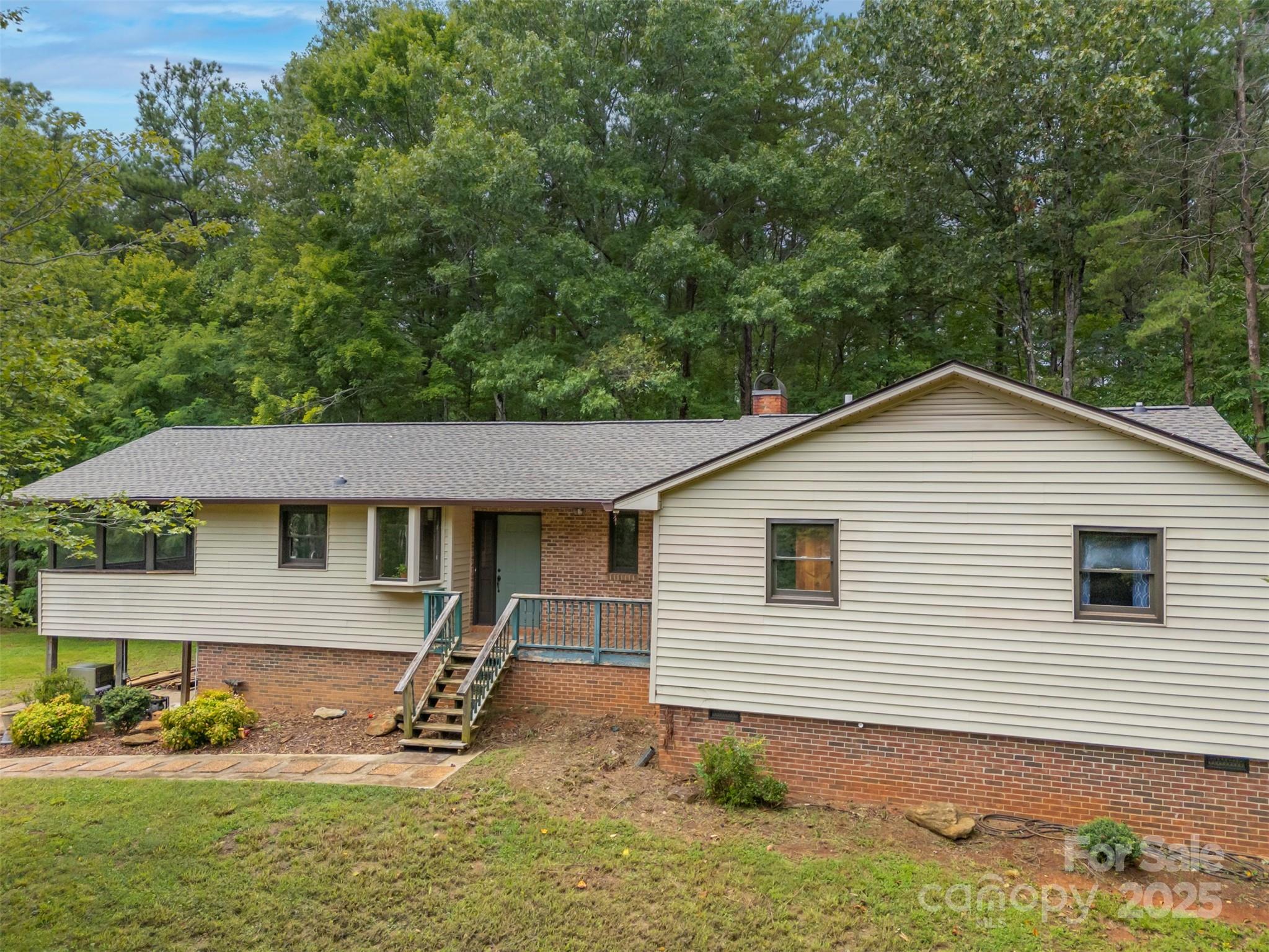307 Owl Hollow Road Mill Spring, NC 28756 - Photo 31 of 31 a view of a house with a yard