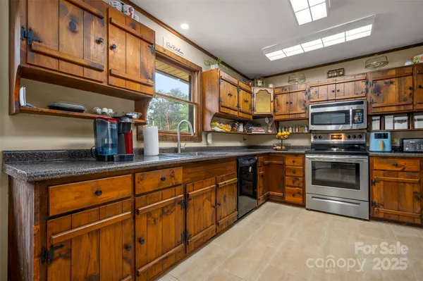 a kitchen with stainless steel appliances granite countertop a stove and cabinets