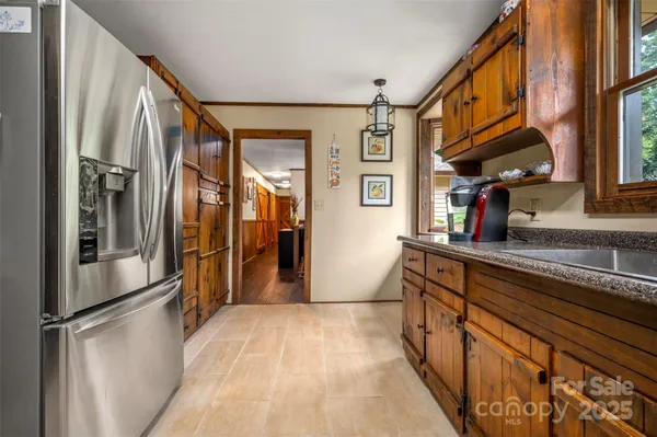 a kitchen with stainless steel appliances granite countertop a refrigerator and a sink