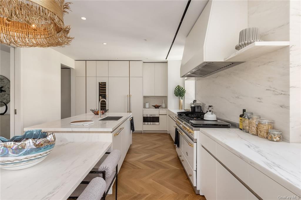1228 Madison Avenue, Unit 8 Manhattan, NY 10128 - Photo 3 of 17 a large kitchen with stainless steel appliances lots of counter space and breakfast area