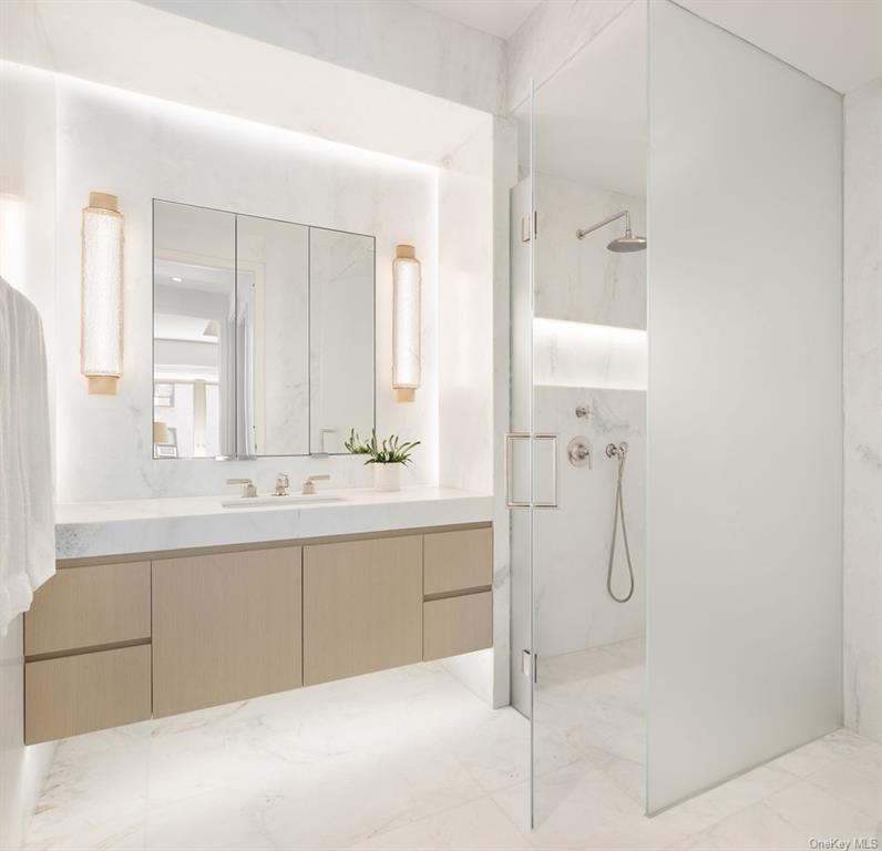 1228 Madison Avenue, Unit 8 Manhattan, NY 10128 - Photo 7 of 17 a bathroom with a tub sink and mirror