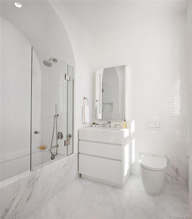 1228 Madison Avenue, Unit 8 Manhattan, NY 10128 - Photo 9 of 17 a bathroom with a sink toilet and shower