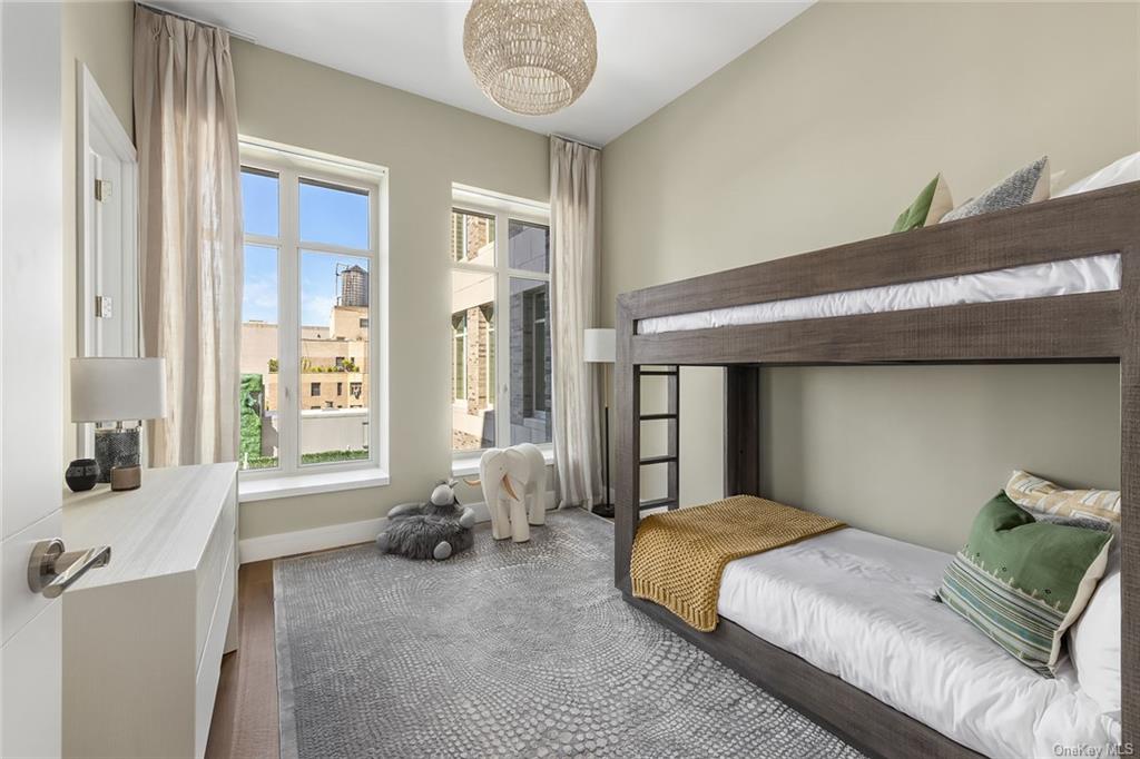 1228 Madison Avenue, Unit 8 Manhattan, NY 10128 - Photo 10 of 17 a bedroom with a bed and a window