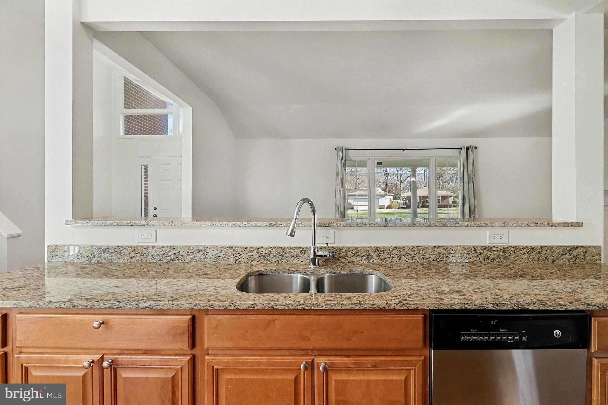 18316 Cabin Road Triangle, VA 22172 - Photo 11 of 42 a kitchen with stainless steel appliances granite countertop a sink and cabinets with wooden floor