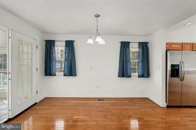 a view of a room with wooden floor and windows