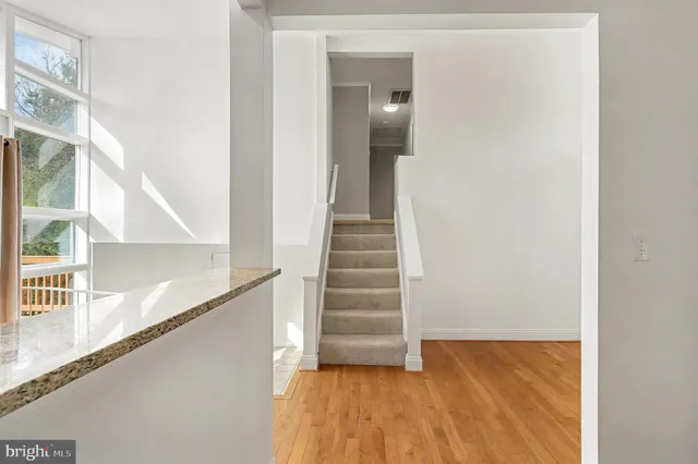a view of entryway and hall with wooden floor