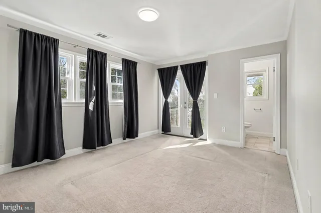 an empty room with closet and a fireplace