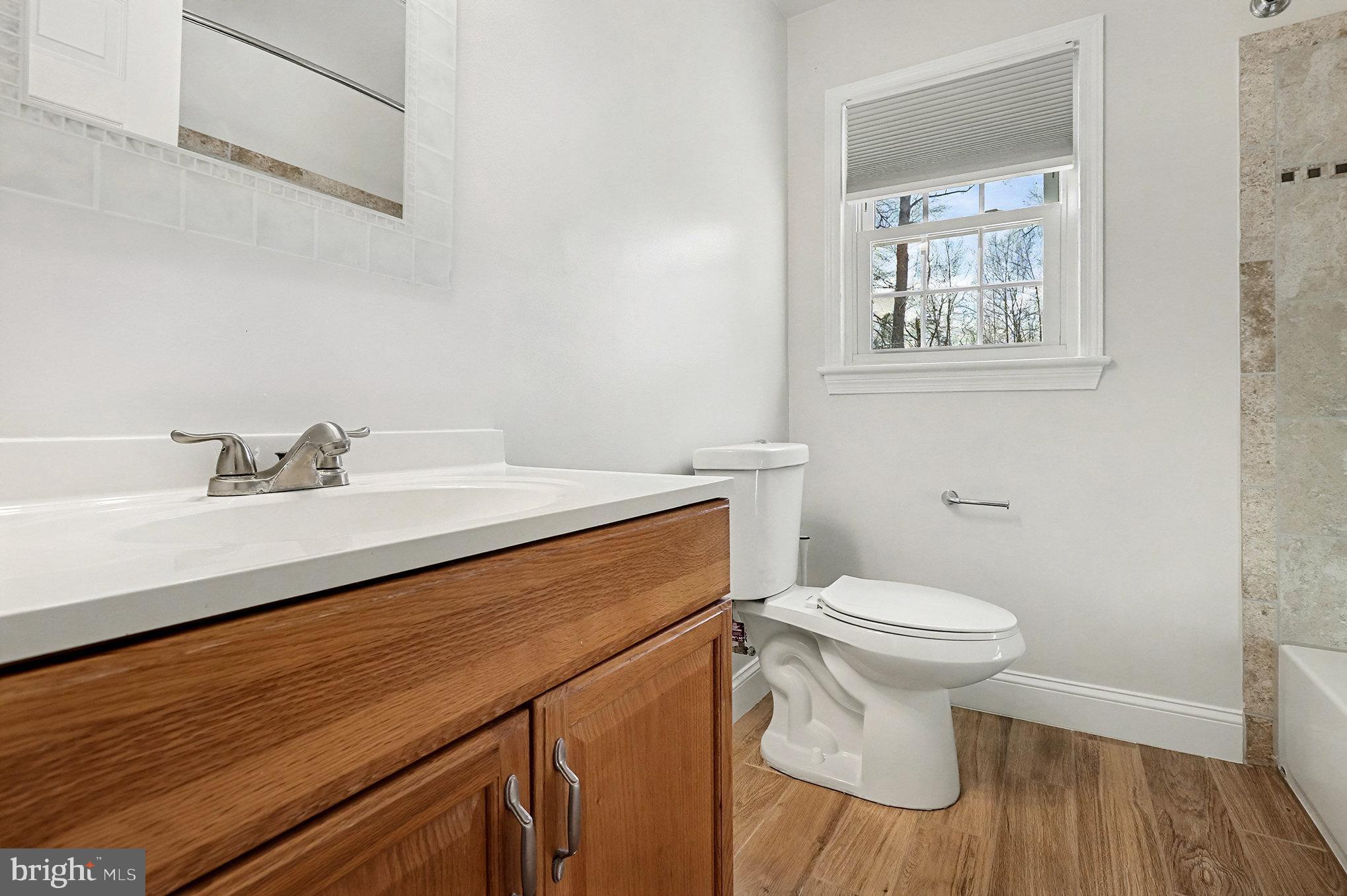18316 Cabin Road Triangle, VA 22172 - Photo 25 of 42 a bathroom with a sink a toilet and a mirror