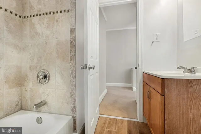 a bathroom with a tub a sink and a shower