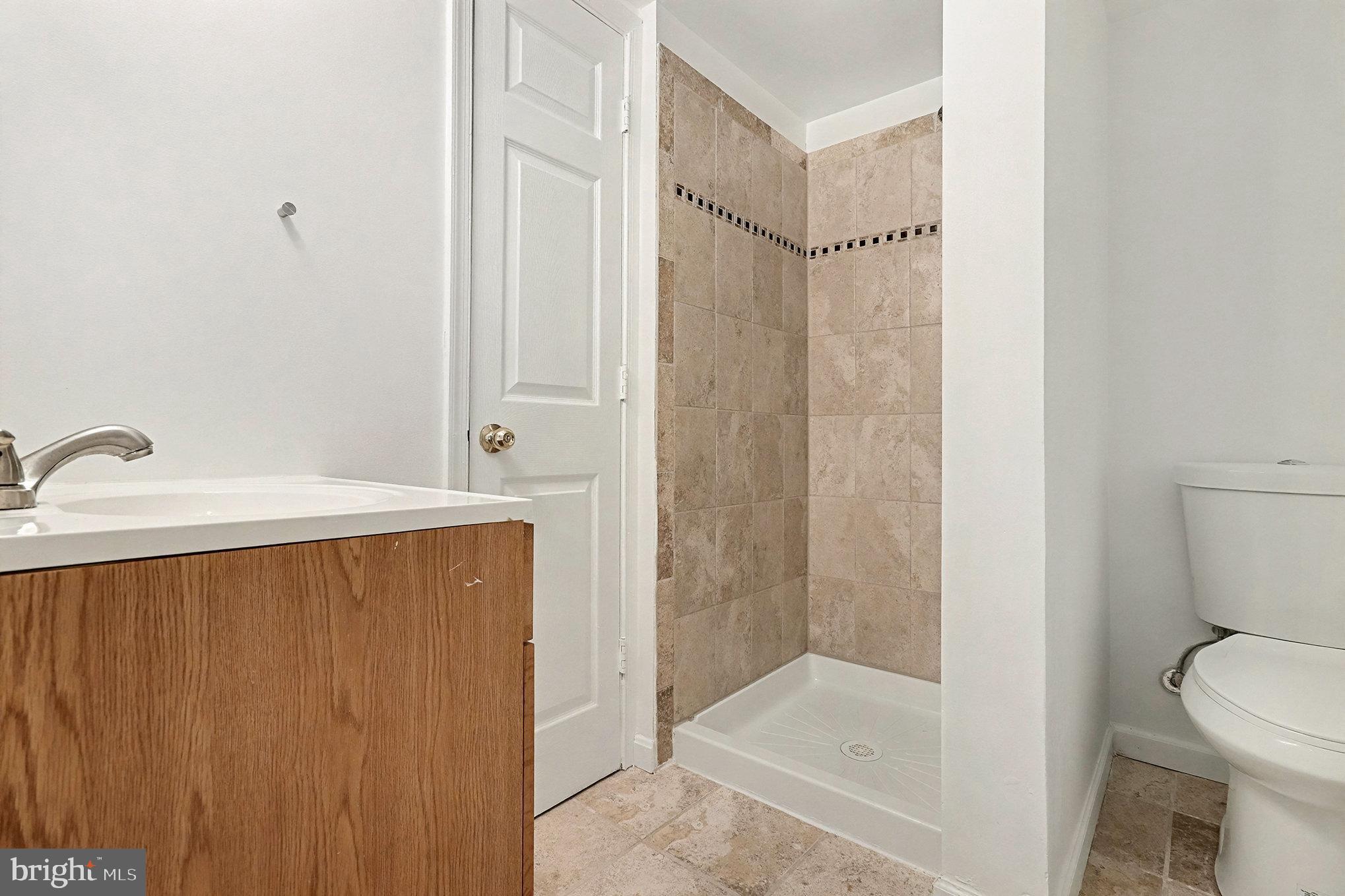 18316 Cabin Road Triangle, VA 22172 - Photo 29 of 42 a bathroom with a shower a toilet and sink