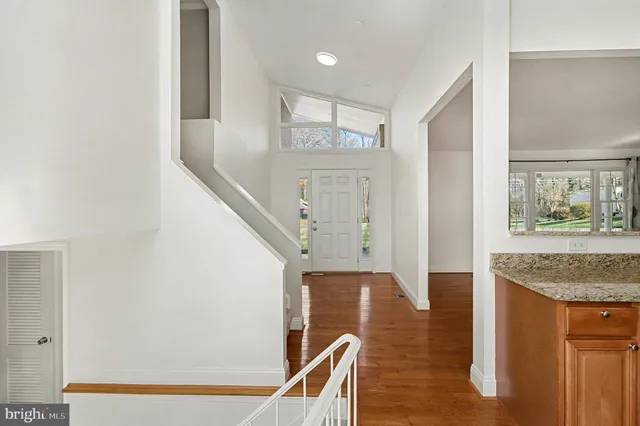 a view of entryway with furniture and wooden floor