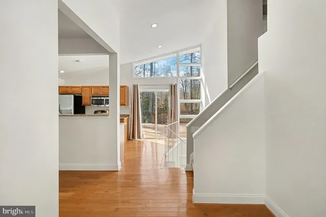 a view of entryway and hall with wooden floor
