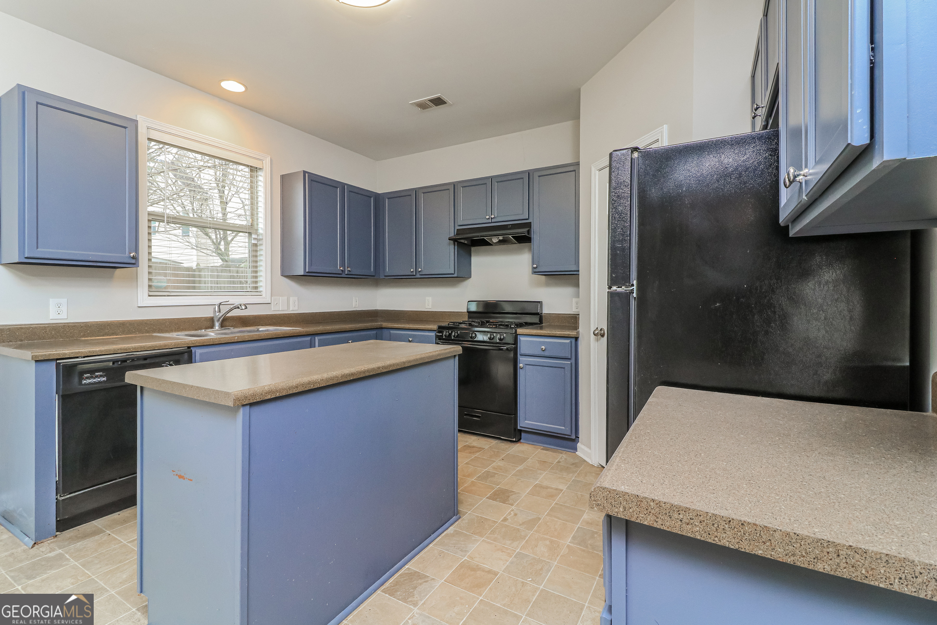 2570 Kolb Manor Circle Southwest Marietta, GA 30008 - Photo 12 of 22 a kitchen with a refrigerator sink and cabinets