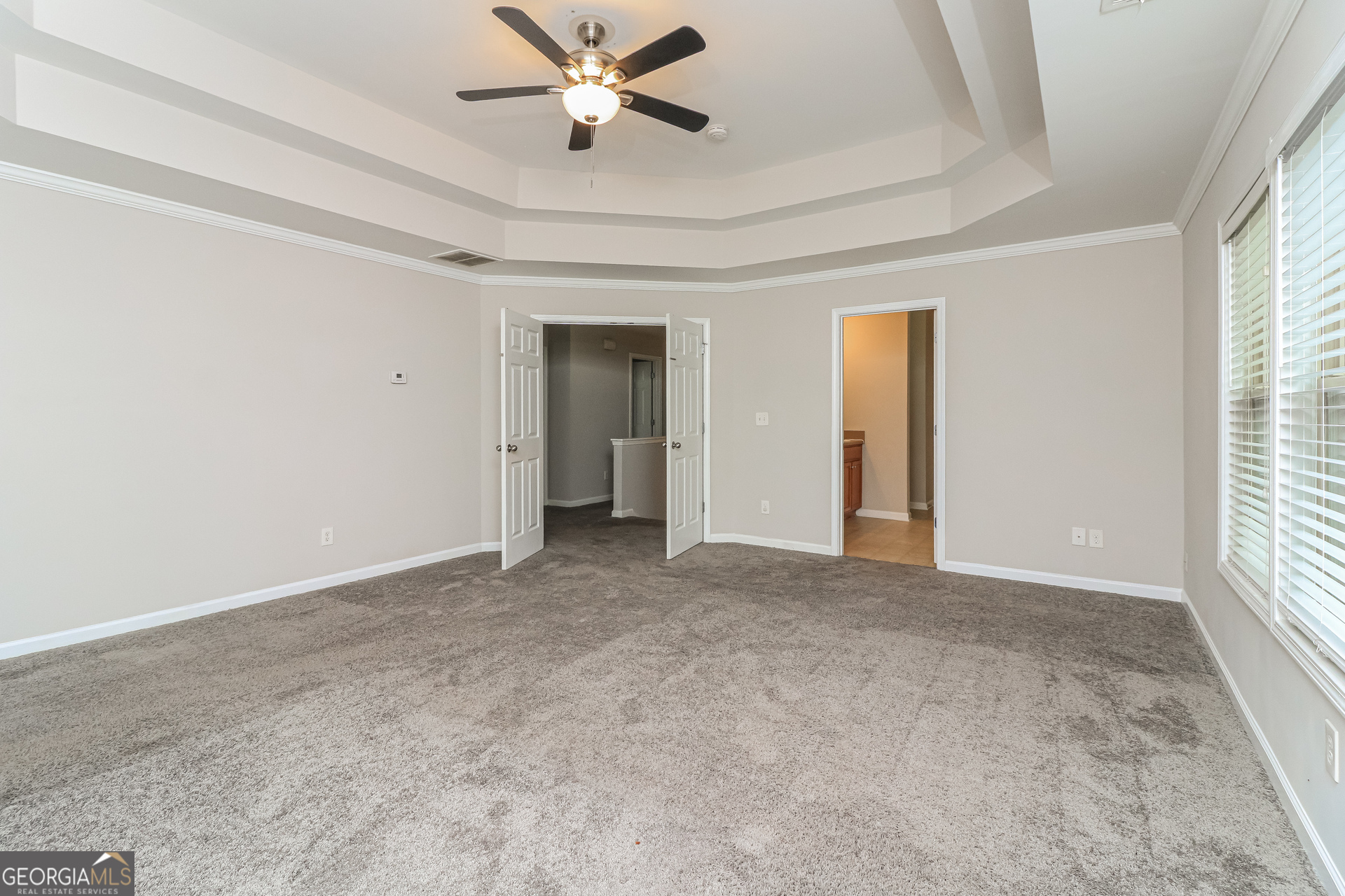 2570 Kolb Manor Circle Southwest Marietta, GA 30008 - Photo 14 of 22 an empty room with chandelier fan and windows