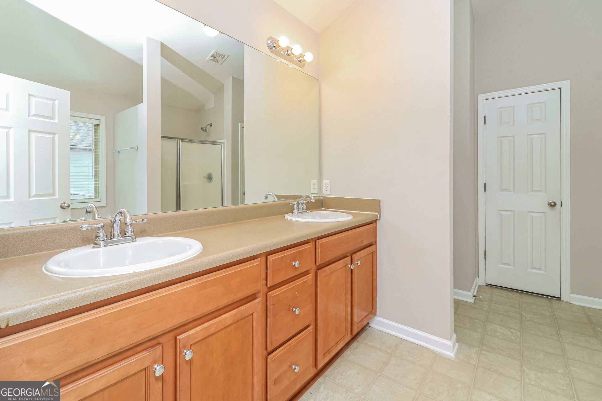 2570 Kolb Manor Circle Southwest Marietta, GA 30008 - Photo 15 of 22 a bathroom with a sink double vanity and a mirror