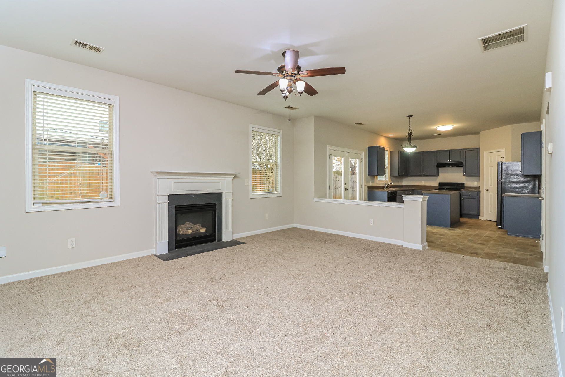 2570 Kolb Manor Circle Southwest Marietta, GA 30008 - Photo 3 of 22 a view of a livingroom with a fireplace a ceiling fan and windows