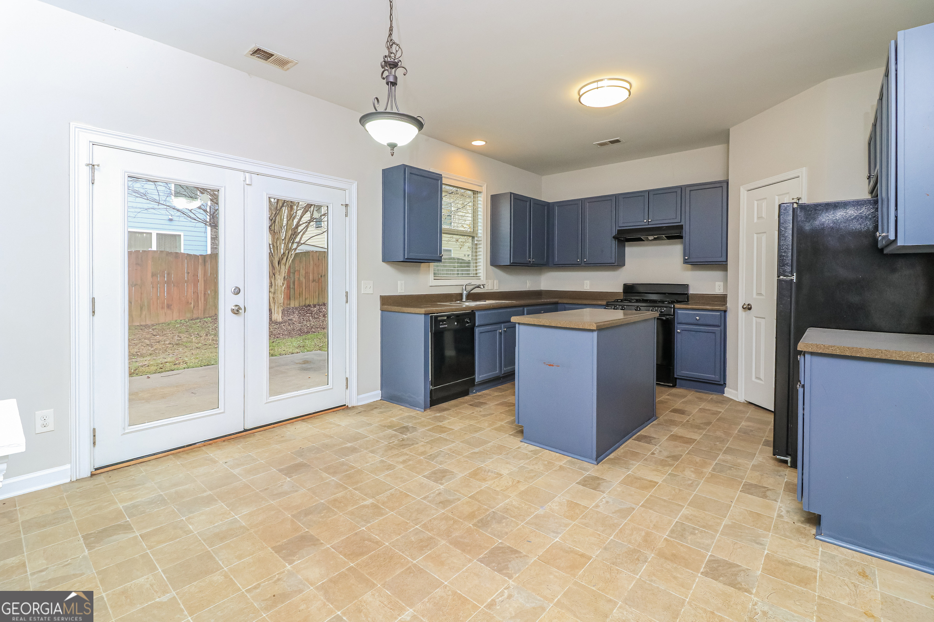 2570 Kolb Manor Circle Southwest Marietta, GA 30008 - Photo 10 of 22 a kitchen with stainless steel appliances granite countertop a stove top oven a sink dishwasher a refrigerator and a cabinets with wooden floor