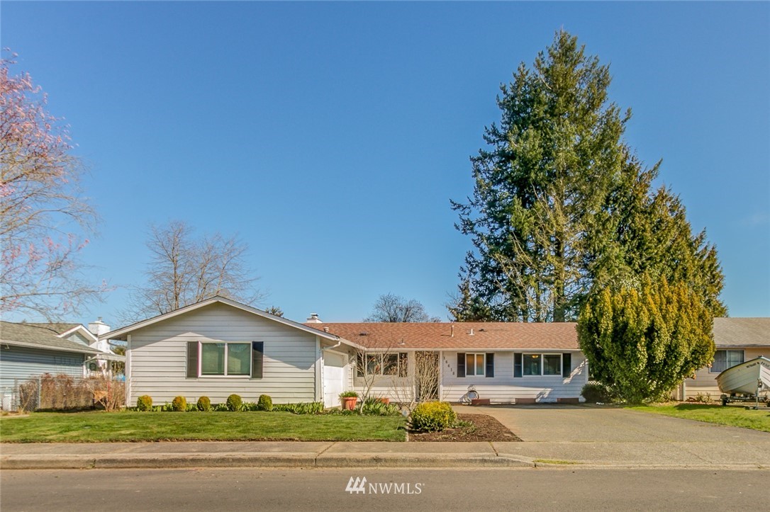 16618 124th Avenue Southeast Renton, WA 98058 - Photo 1 of 21 a view of a big house with a yard and plants