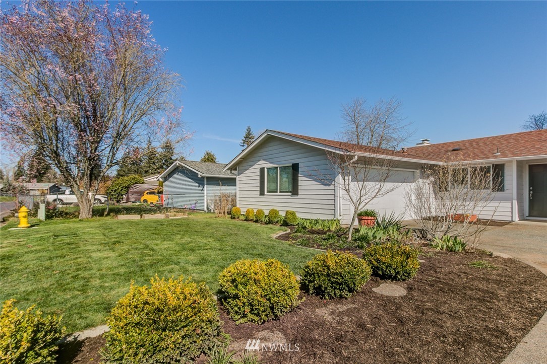 16618 124th Avenue Southeast Renton, WA 98058 - Photo 2 of 21 a view of a yard in front of house