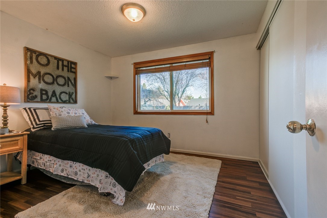 16618 124th Avenue Southeast Renton, WA 98058 - Photo 12 of 21 a bedroom with a bed and wooden floor