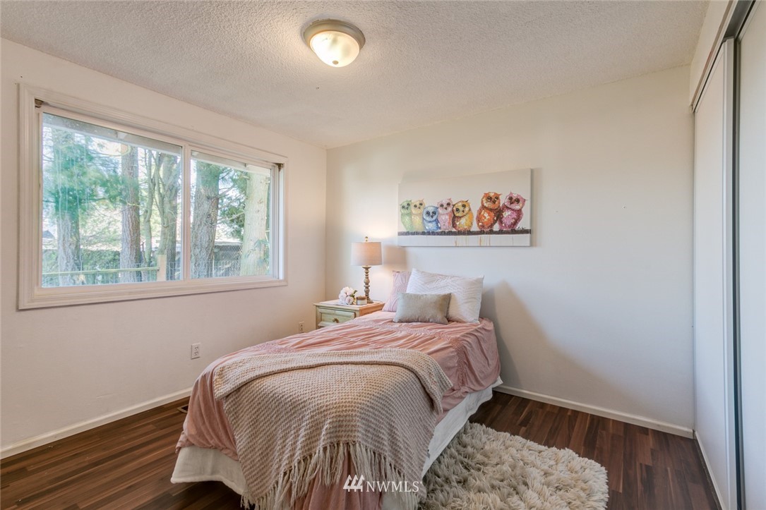 16618 124th Avenue Southeast Renton, WA 98058 - Photo 13 of 21 a bedroom with a bed and a painting on the wall