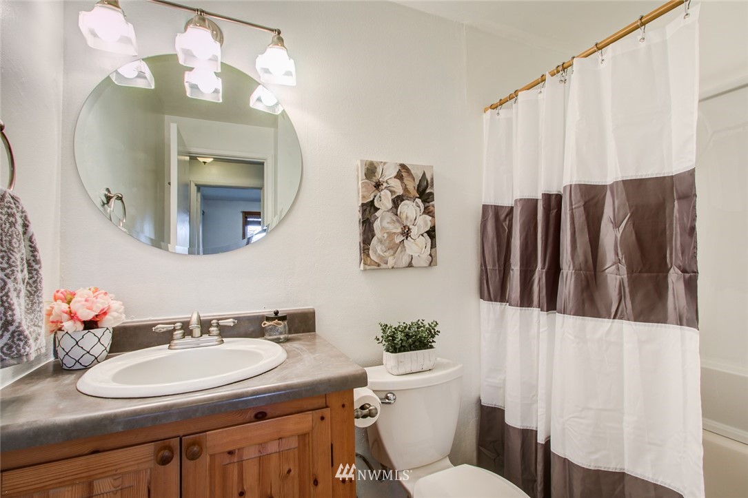 16618 124th Avenue Southeast Renton, WA 98058 - Photo 14 of 21 a bathroom with a sink vanity mirror and toilet