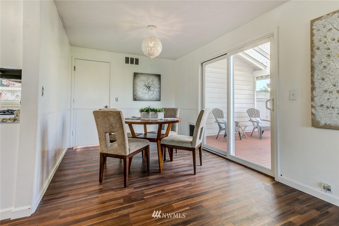 16618 124th Avenue Southeast Renton, WA 98058 - Photo 15 of 21 a view of a dining room with furniture and wooden floor